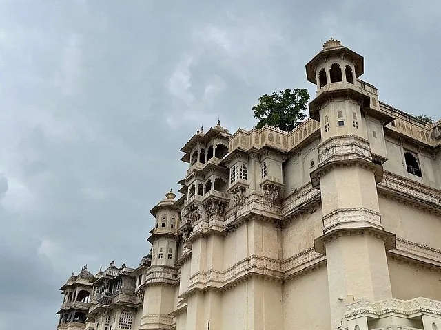 A low-angle view of the towering white facade of City Palace with intricate balconies.