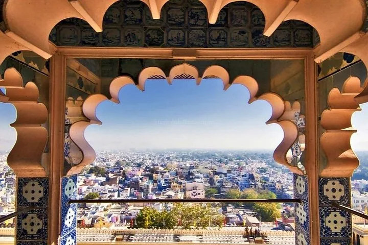 A scenic view of a city through an ornate, scalloped archway.